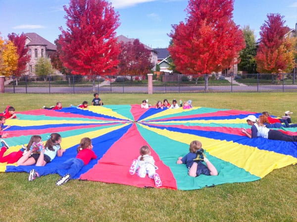 Picture of kids playing on a parachute