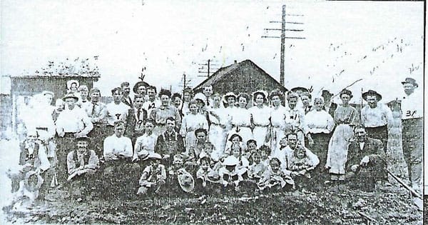 Picture of Sedalia firefighters, many of whom were women, posed with their families