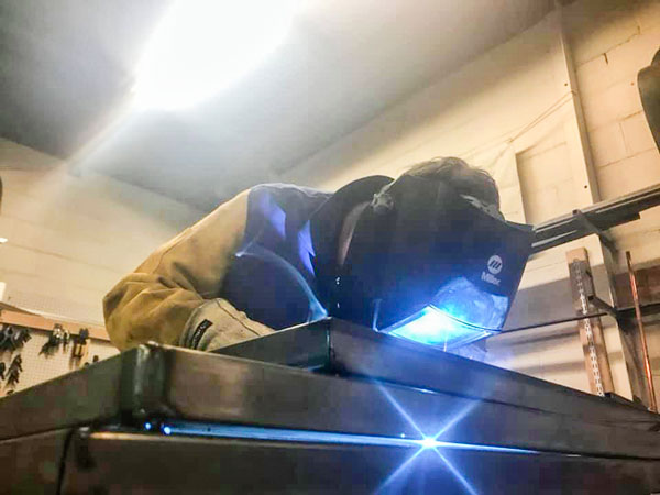 Photo of Harry Abramovitz learning welding