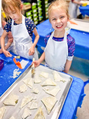 Photo DCSM girls making Albanian feta pies