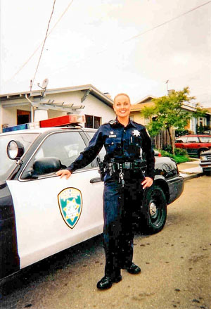 Photo of Shannon Jensen by her patrol car