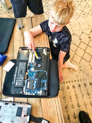 Photo of third grader installing a stick of RAM