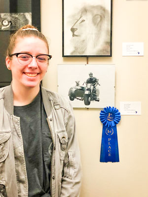 Photo of Claire Blaeser and her pencil drawing