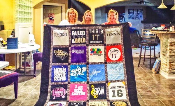 Photo of Kathleen Steffe, Lynn Zahorik and Claire Bochner display quilt