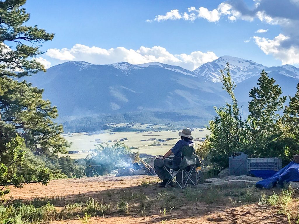 Photo of a happy camper enjoying the view from a free.