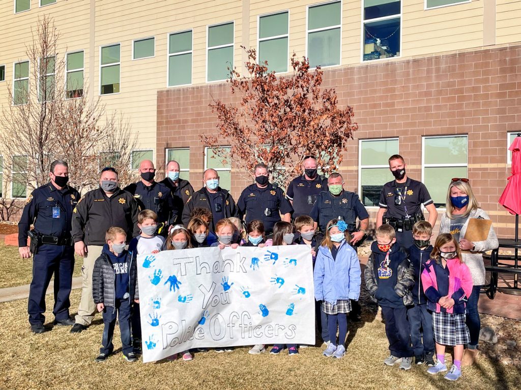 Photo of American Academy kids with Douglas County Sheriff and deputies