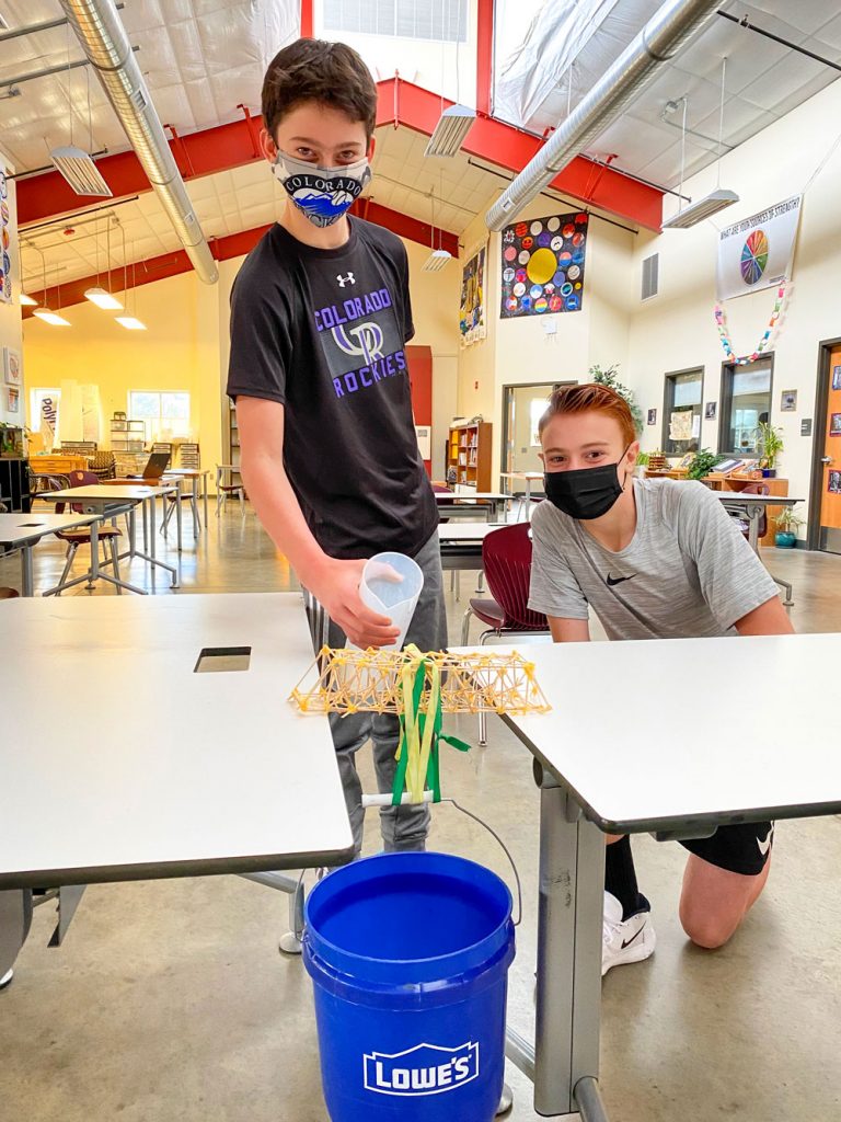 Bryce Grafton and Logan Kenney work on their designed bridge