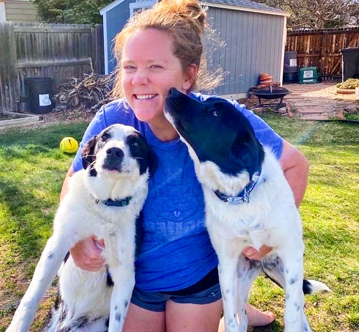 Photo of math teacher MacKenzie Boeckmann and her two border collie mixes Piper and Cannon