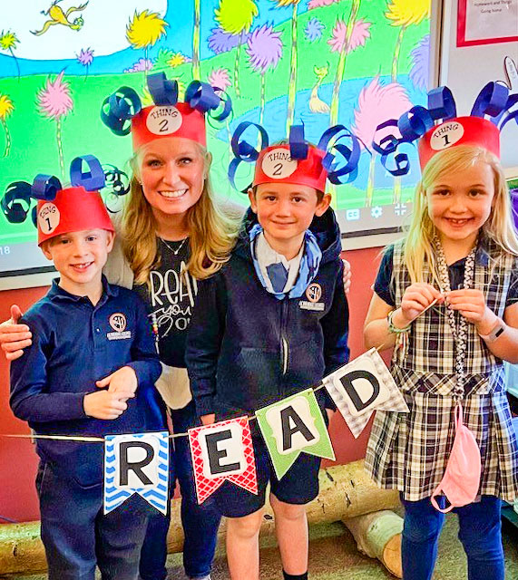 Photo of first grade teacher Erin Dill, students Dylan McNitt (left), Weston Sakosky and Charlotte Rigg (far right)