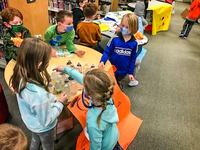 Photo of Student entrepreneurs of Calming Kids business show interested first grade