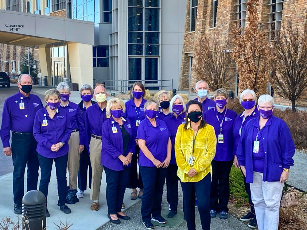 Photo of Marti Jones, in yellow, with volunteers at Castle Rock Adventist Hospital