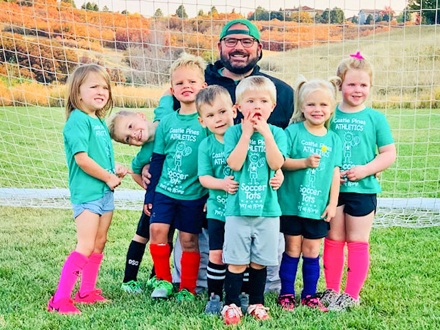 Photo of Volunteer coach Donny McCleery gets silly with the soccer tots.