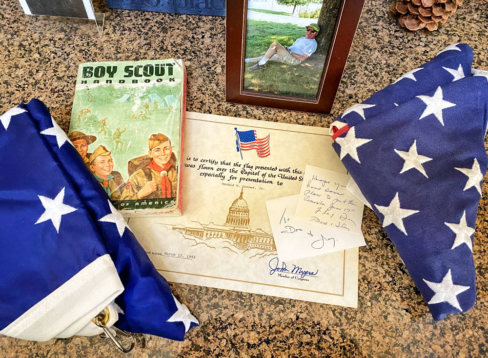 Photo of Michael Conner's Boy Scout handbook and other memorabilia.