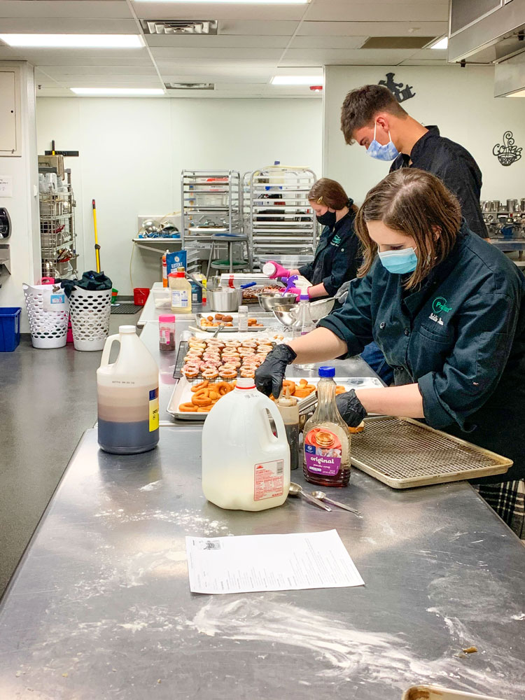 Photo of ProStart students working in the culinary lab kitchen at ThunderRidge High School.