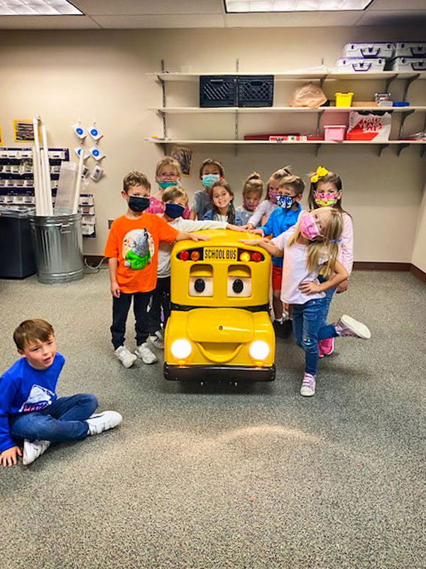 Photo of Robotic Buster the Bus interacts with students