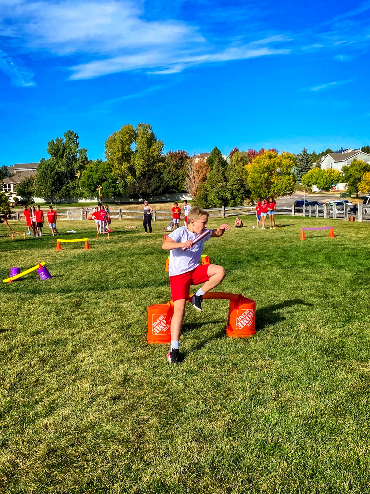 Photo of Wearing red and white to represent Japan, fifth grade student Caleb M. participates in a relay race 