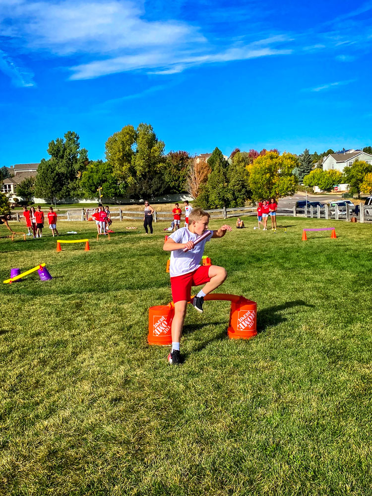 Photo of Wearing red and white to represent Japan, fifth grade student Caleb M. participates in a relay race