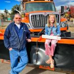 Photo of Timber Trail Elementary fifth grade student Leyna Sanford sits atop a snowplow
