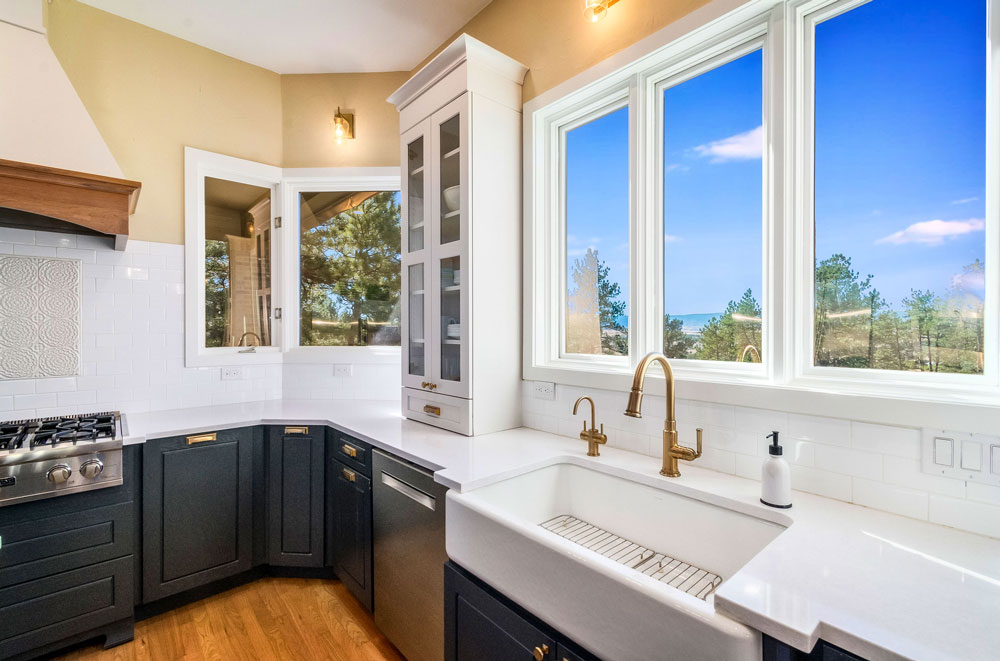 Photo of large windows that capture the beautiful trees and mountain views outside.