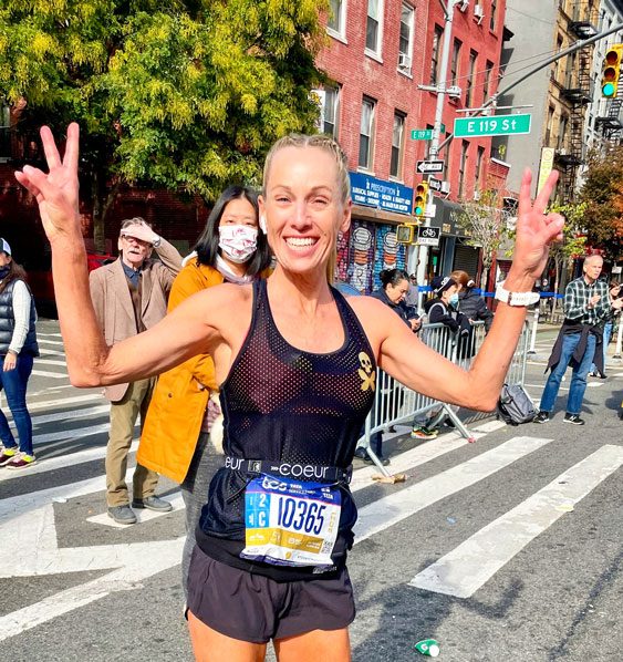 Photo of Stacia Wilkins who is all smiles at the New York City Marathon.