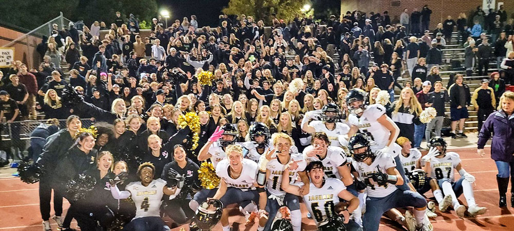 Photo of Rock Canyon High School football team and school fans.
