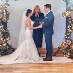 Photo of RHMS teacher Judi Holst officiating the wedding of two of her former students, Alana Rainosek and Ethan Myers,