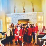 Photo of Santa visiting the ornament exchange.
