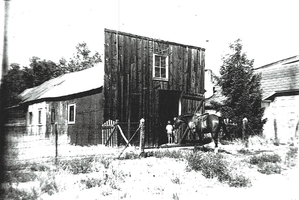 Historic photo of the Victor Marquis’ blacksmith shop and livery. 