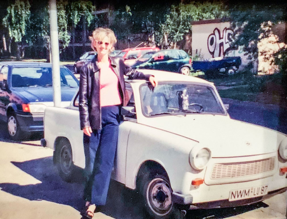 Photo of Ricarda Dietsch stands beside her iconic Trabant circa 1994