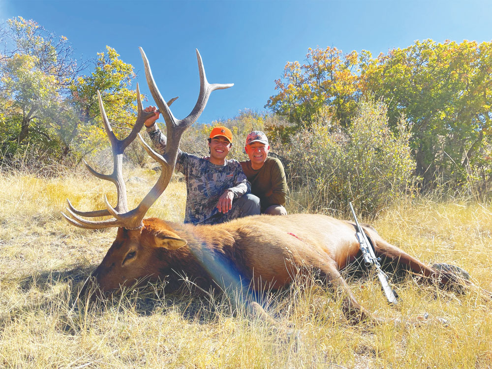 Photo of Greg Vigil with his son Eli during the first rifle season of 2021 hunting