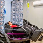 Photo of a client relaxes at an intravenous (IV) drip spa.