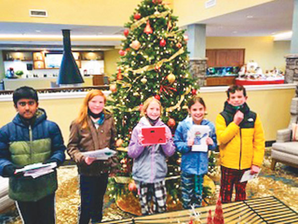 Photo of fifth grade Timber Trail students delivering hand-crafted holiday cards.