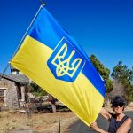 Photo of Ada Vernon stands proudly beside the Ukrainian flag