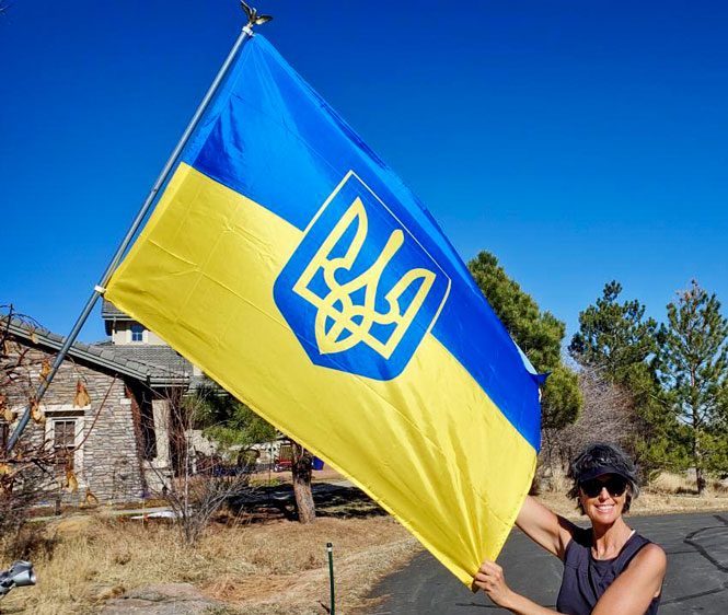 Photo of Ada Vernon stands proudly beside the Ukrainian flag