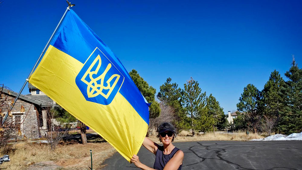 Photo of Ada Vernon stands proudly beside the Ukrainian flag