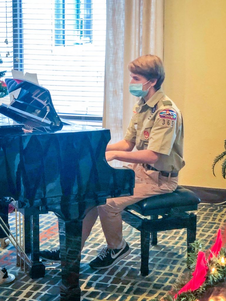 Photo of Russell Christensen plays the piano at Legacy Village