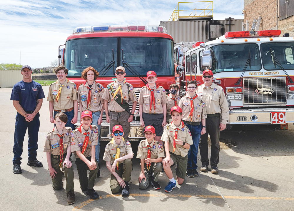 Pictured right: Members of Boy Scout Troop 316 at the South Metro Fire Rescue training facility in Parker. Front row kneeling (left to right): Will Knox, Lucas Gulliver, Asa Kelley, Jack Muggenthaler and Evan Martin; Back row standing (left to right): Jeff Pepper, Miller Duval, Alex Kohl, Tyler Pepper, Kiefer Duval, Landon Gulliver, Adam Knox and Scoutmaster DeLane Duval.