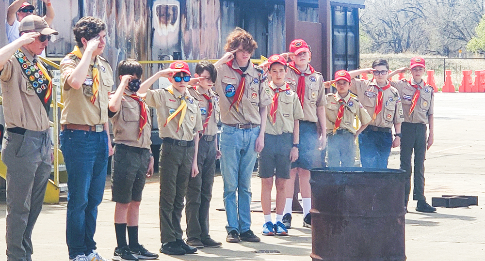 Members of Boy Scout Troop 316 (left to right) Tyler Pepper, Miller Duval, Landon Gulliver, Asa Kelley, Will Knox, Alex Kohl, Evan Martin, Kiefer Duval, Jack Muggenthaler, Adam Knox and Lucas Gulliver salute during a flag retirement ceremony.