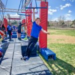 Photo of BRE Aiden B. concentrates on the swinging bars