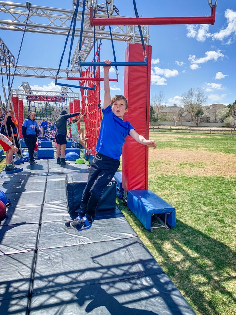 Photo of BRE Aiden B. concentrates on the swinging bars