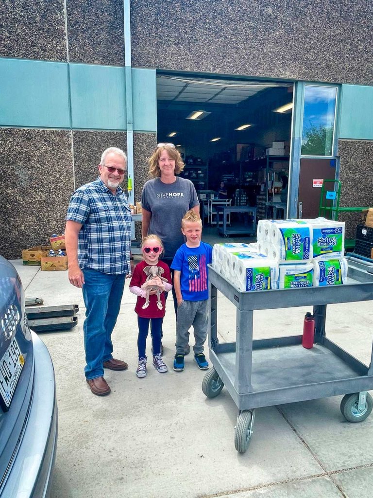 Photo of Help & Hope Center Executive Director Dan Marlow receiving donation from little boy.