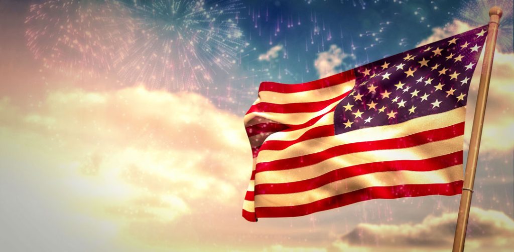 photo of flag in wind with clouds