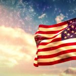 photo of flag in wind with clouds