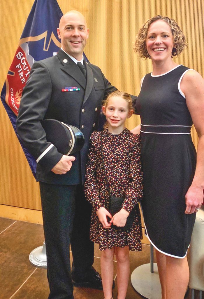 photo of man in uniform with family