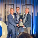 photo of three men holding trophy