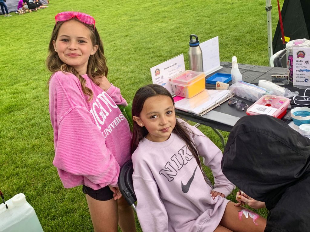 photo of two girls hanging outside at event