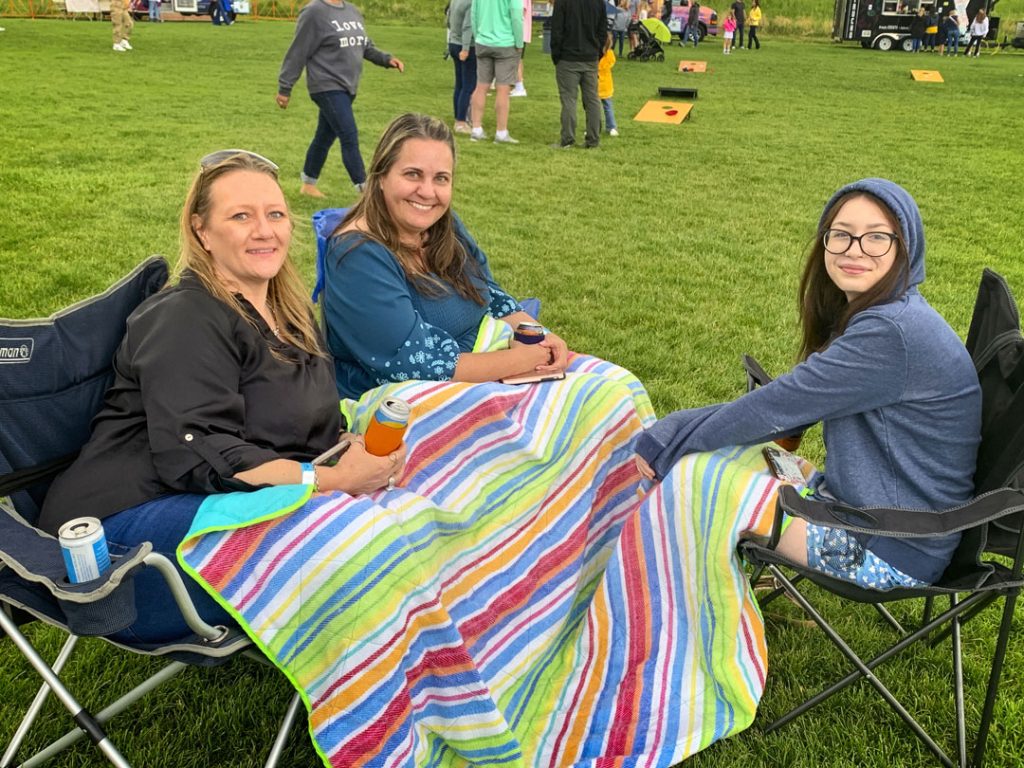 people enjoying outside event with blanket