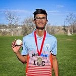 photo of teen holding cricket ball