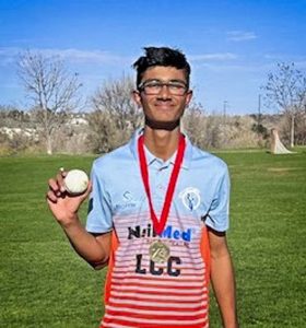 photo of teen holding cricket ball