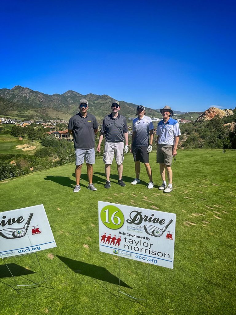 group of 4 golfers standing outside